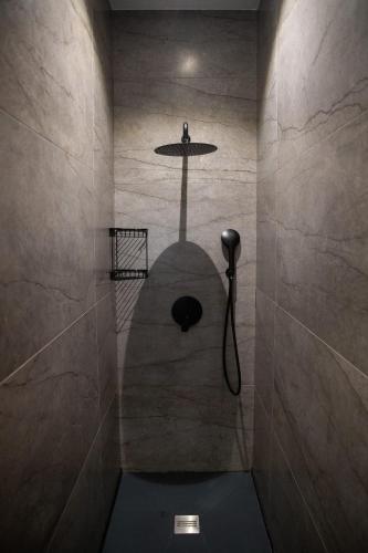 a bathroom with a shower with a sink at Pebbles Resort in St. Paul's Bay