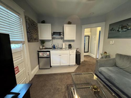 a living room with a couch and a kitchen at Downtown Lake Eola Historic House 1 OR 2 BED in Orlando