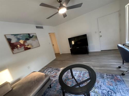 a living room with a couch and a tv at Location Lake Eola View 1 Bedroom condo in Orlando