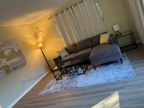 a living room with a couch and a table at Vintage 2 Bedroom Condo Lake Eola View in Orlando