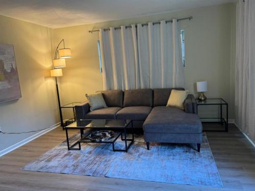 a living room with a couch and a coffee table at Vintage 2 Bedroom Condo Lake Eola View in Orlando