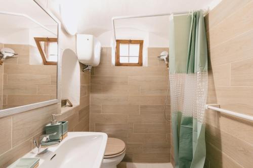 a bathroom with a sink and a toilet and a mirror at BHR - Il Nido di Trevi in Trevi