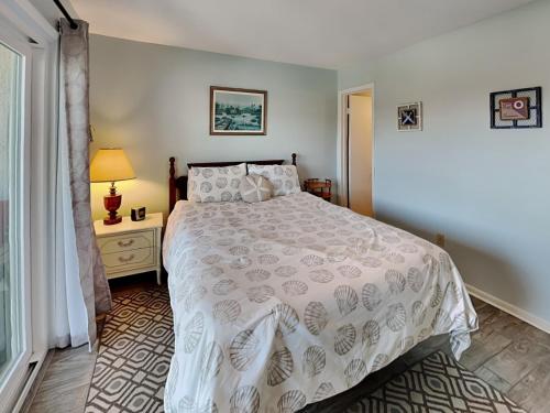 a bedroom with a bed with a white bedspread at Lighthouse Point 3B in Tybee Island
