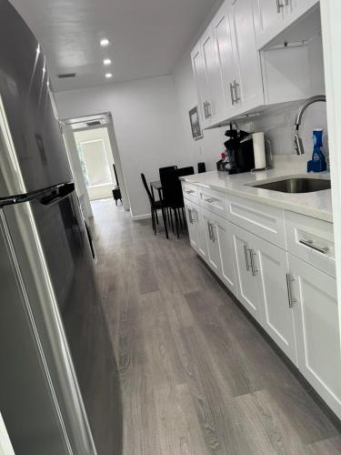 a kitchen with white cabinets and a stainless steel refrigerator at Renovated Condo Lake Eola View Great Location in Orlando