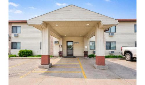 a large white building with a front door at OYO Hotel Pipestone MN, Canterbury Park in Pipestone
