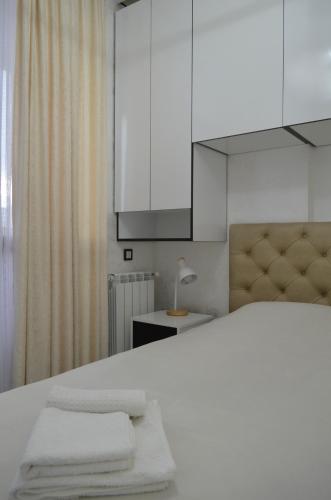 a bedroom with a bed with two towels on it at PushkinApart in Batumi