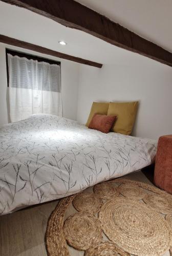 a bed sitting in a room with a window at Cocooning et Charmante Maisonnette Provençale, avec Extérieurs privatifs et Accès Piscine in Orgon