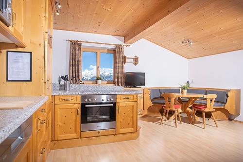 a kitchen with a table and a dining room at Alpenrelax Krepperhütte in Volders