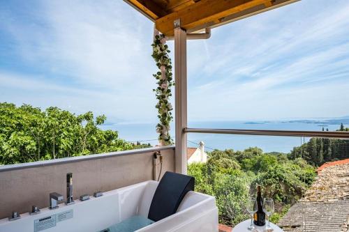 a bathroom with a tub and a view of the ocean at Art House with Seaview & Jacuzzi by Konnect in Spartýlas
