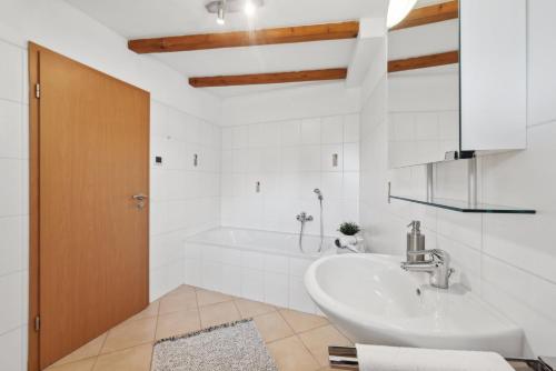 a bathroom with a sink and a tub at ANDRISS - Travel & Work - 5 BR - Kitchen - Parking in Kaiserslautern