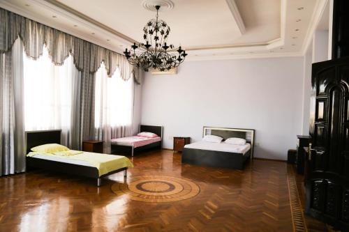 a living room with two beds and a chandelier at Premier Villas in Mardakan