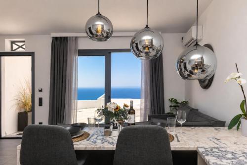 a dining room with a view of the ocean at Tinian Sunset Villa in Istérnia