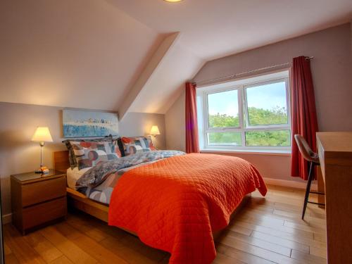 a bedroom with a bed and a window at Culver House Hotel in Port-Eynon