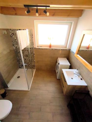 a bathroom with a shower and a toilet and a sink at Przystanek Borucino in Borucino