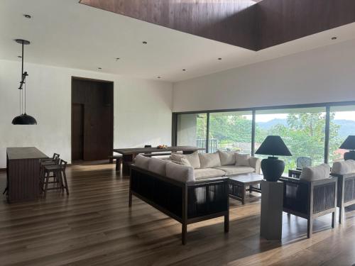 a living room with a couch and a table at Cinnamon Sunset Villa in Kurunegala