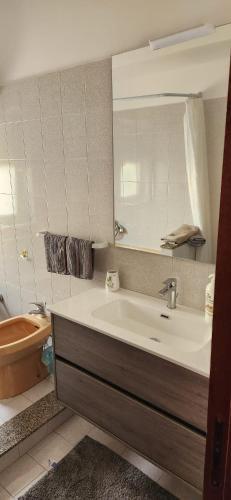 a bathroom with a sink and a toilet and a mirror at Casa Richiusa Calogero in Blufi