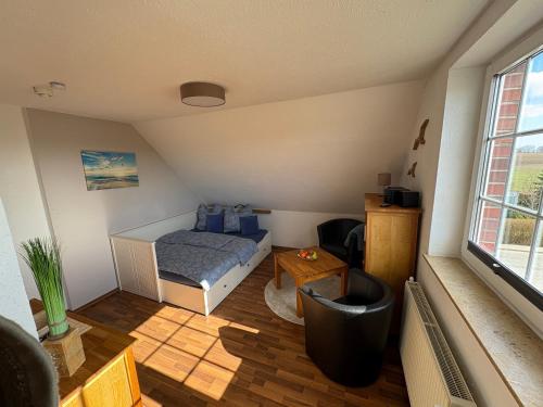 a small room with a bed and a table at Ostseekoje Koje 6 in Süssau