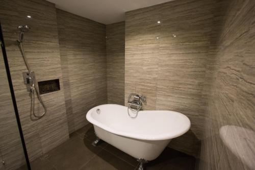 a bathroom with a white sink and a shower at Arte Hotel - SHA Extra Plus in Bangkok