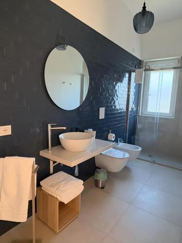 a bathroom with two sinks and a mirror at Pilone del Monaco Apartment 9 in Vieste
