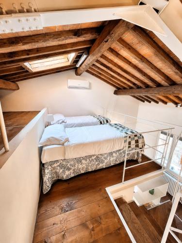a bedroom with a bed in a room with wooden ceilings at il "Terrazzino" nel cuore di Siena in Siena