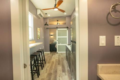 a bar with stools and a ceiling fan at Greystone - Cozy 2-bedroom Tiny Home in soothing Anderson SC on Lake Hartwell in Anderson