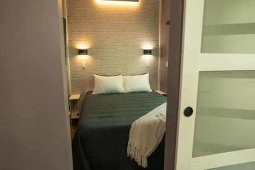 a bedroom with a bed with two pillows at Greystone - Cozy 2-bedroom Tiny Home in soothing Anderson SC on Lake Hartwell in Anderson