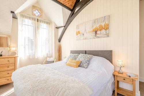 a bedroom with a large white bed and a window at 4 Bed in Bridport oc-58847 in Powerstock