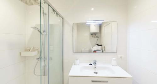 a white bathroom with a sink and a shower at Ocean View 3 in Los Cristianos