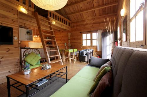 a living room with a couch and a table at CHALET Meleze Etapeboisee in Fumay