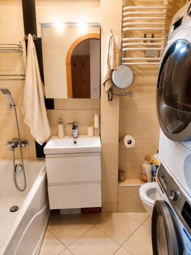 a small bathroom with a sink and a toilet at Apartament na Libelta in Wągrowiec
