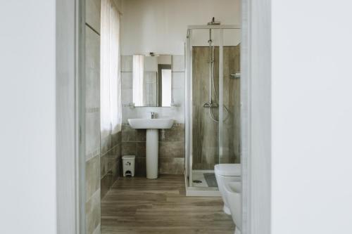 a bathroom with a shower toilet and a sink at Aura Residence in San Biagio