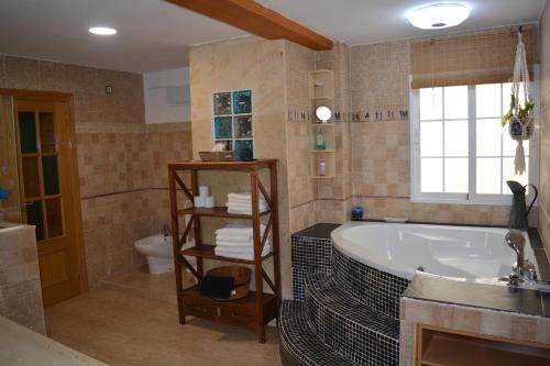 a bathroom with a tub and a sink and a toilet at Casa Paola in Buñol