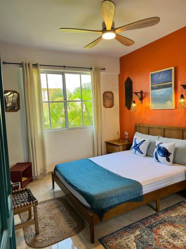 a bedroom with a bed and a ceiling fan at Casa Lio, Caribbean Pool Residence in Boca Chica