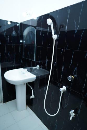 a bathroom with a shower and a sink at Elite moon hotel in Kallady