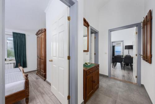 a bedroom with a door leading to a dining room at Apartment Tomic Makarska in Makarska