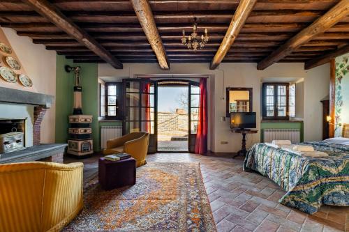 a bedroom with a bed and a fireplace at La finestra sul Chianti in Radda in Chianti