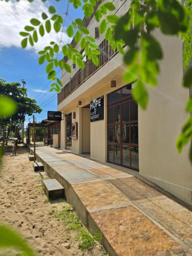 a building with a sidewalk in front of it at Portal do Kite in Barra Grande
