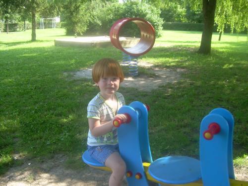 a young boy is playing in a playground at Éva vendégház in Egerszalók