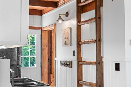 a kitchen with white walls and a wooden ladder at Whispering Bass Lodge 3BDR in Kimberling City