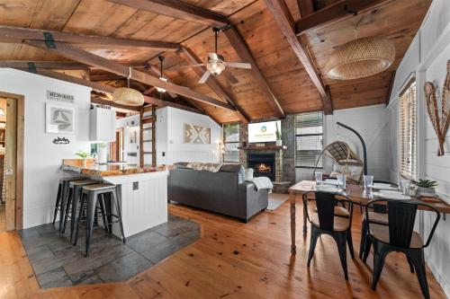 a kitchen and living room with a table and chairs at Whispering Bass Lodge 3BDR in Kimberling City