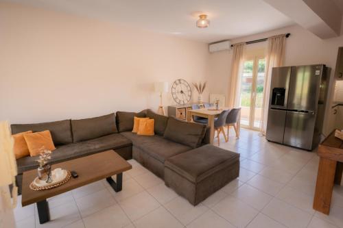 a living room with a couch and a table at Ithaki Apartments in Paramythia