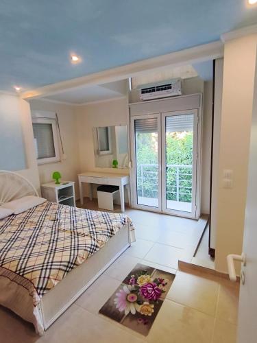 a bedroom with a bed with flowers on the floor at Jones house in Nea Fokea