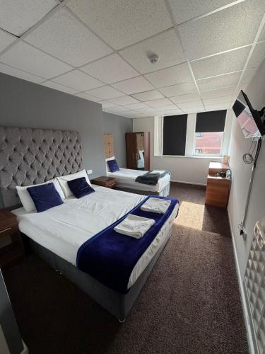 a bedroom with a large bed with blue pillows at Parkview Residence in Manchester
