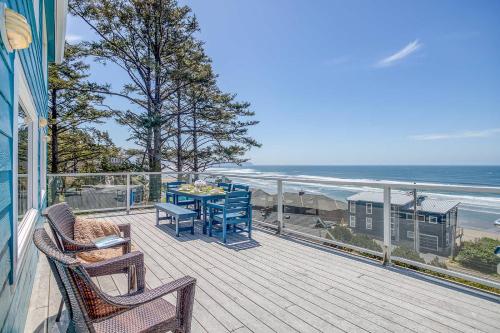a balcony with a table and chairs and the ocean at Serendipity -A Happy Surprise Unit A in Oceanside