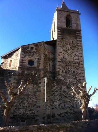 a tall brick building with a bell tower at Hostal Rusó SC in Llivia