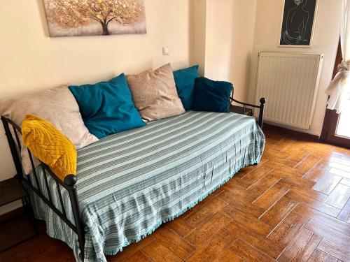 a bed with blue pillows in a room at Sergio's homes in Mélanes