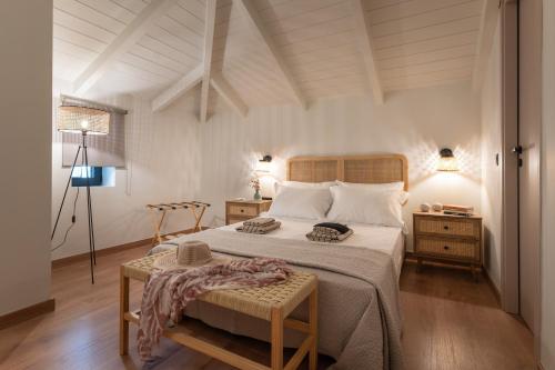 a bedroom with a large bed and a table at Olea Stone Villa in Pylos