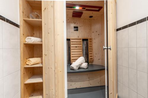 a room with wooden shelves in a bathroom at ALPENAPART Ladis - Premium Family Apartments in Ladis