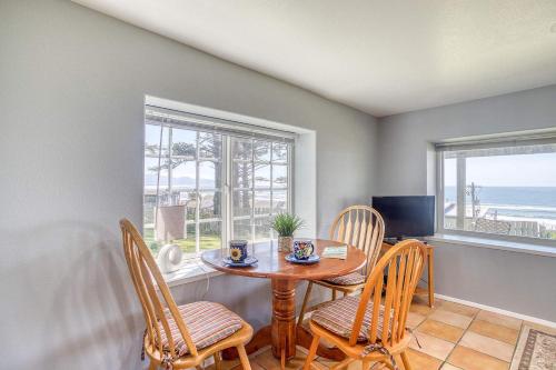 a dining room with a table and chairs and the ocean at Serendipity -A Happy Surprise Unit B in Oceanside