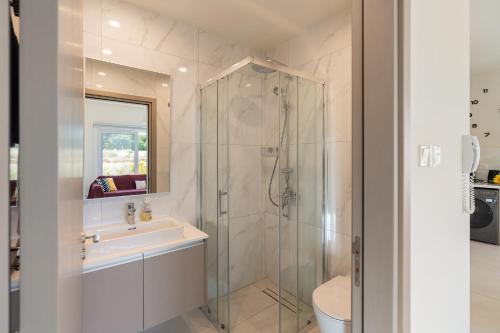a bathroom with a shower and a sink at The Icon 001 - Superior 2BR Apartment with Pool & Gym, Mythical Seas - Protaras in Paralimni